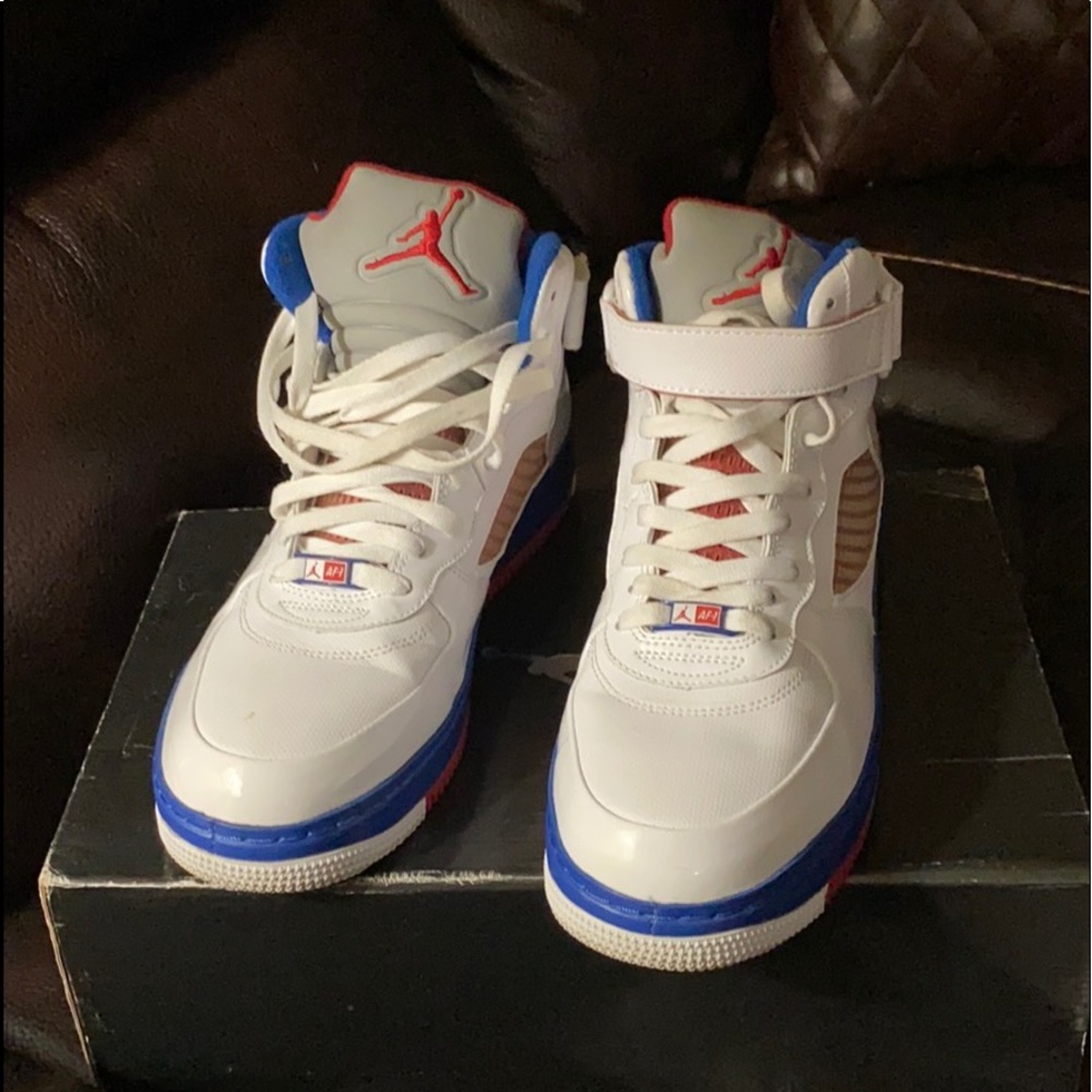 A pair of Jordans red white and blue